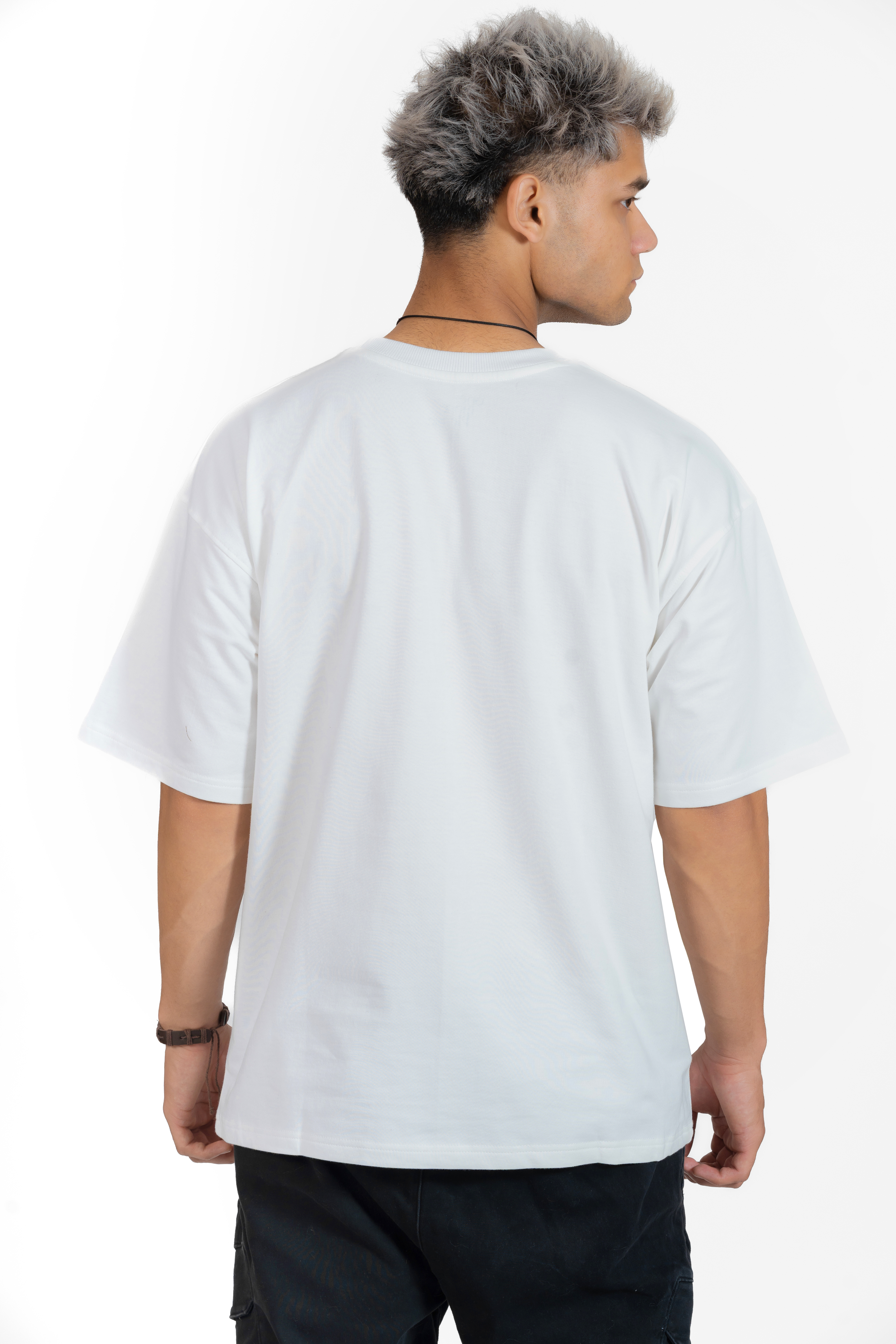 Man wearing a plain white t-shirt on a white background